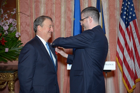 Ambassador Delattre bestowing the badge of a Chevalier of the Legion of Honor on Howard Milstein.
